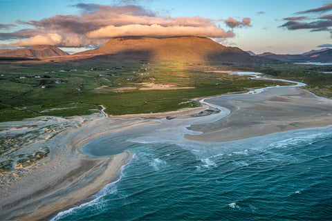 Aerial sunset view of White Strand beach in Connemara with mountains and rivers meeting the Atlantic coast