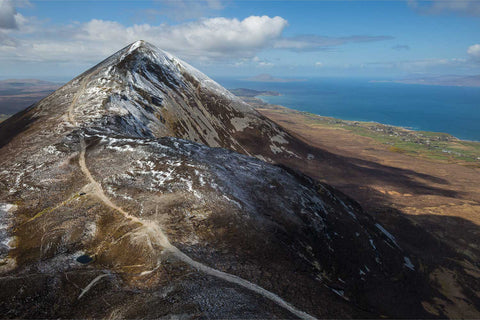 Aerial view of snow-dusted Croagh Patrick with Clare Island in the distance, Co. Mayo, Ireland, fine art aerial photograph by Peter Cox