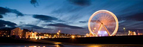 Long exposure of carnival Ferris wheel at night on the coast, Tramore, Co. Wexford, fine art landscape photograph by Peter Cox