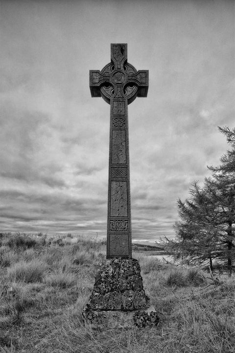 Black and white Celtic cross silhouette on Green Isle, historic McDonald burial ground, Scotland — fine art landscape photograph by Peter Cox