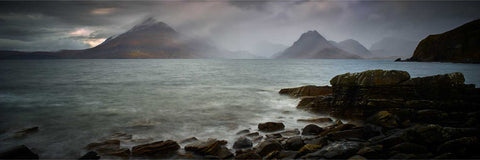 The Cuillin mountains rising dramatically through mist and rain seen from the shores of Elgol on the Isle of Skye