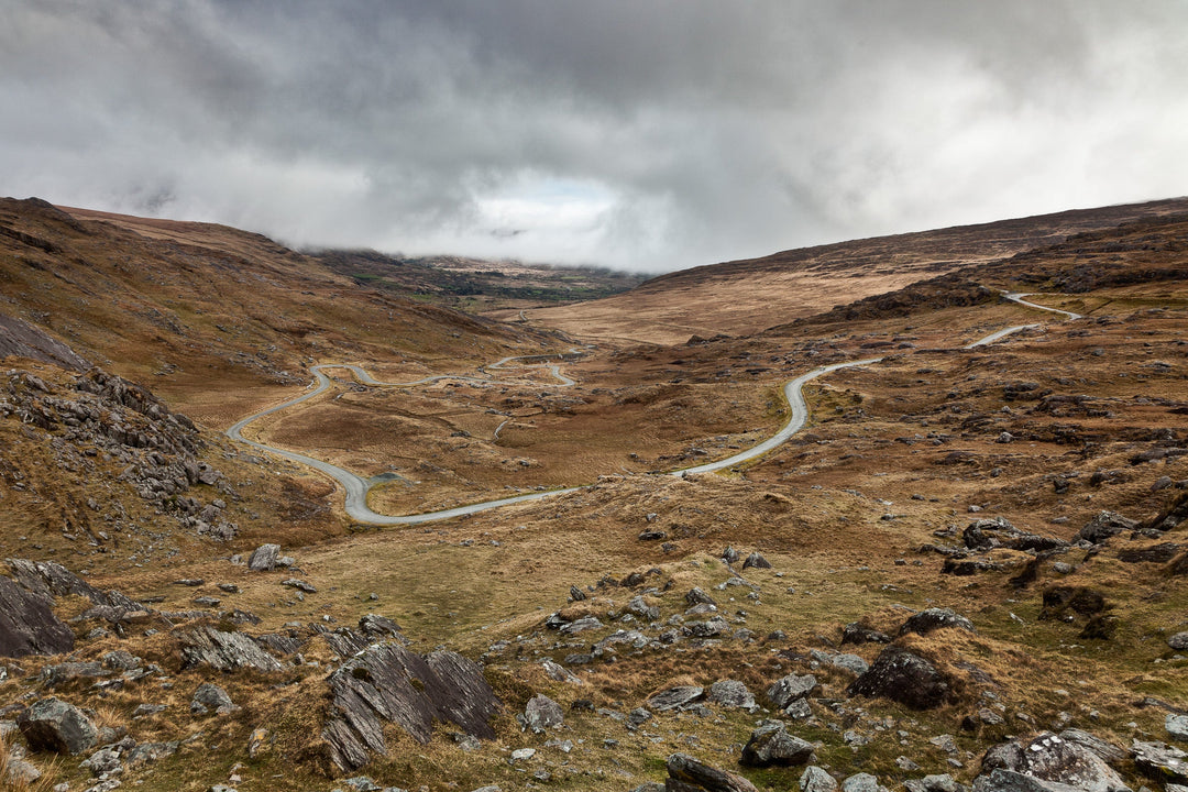 The Healy Pass, County Cork, the road winding down through the valley under heavy cloud