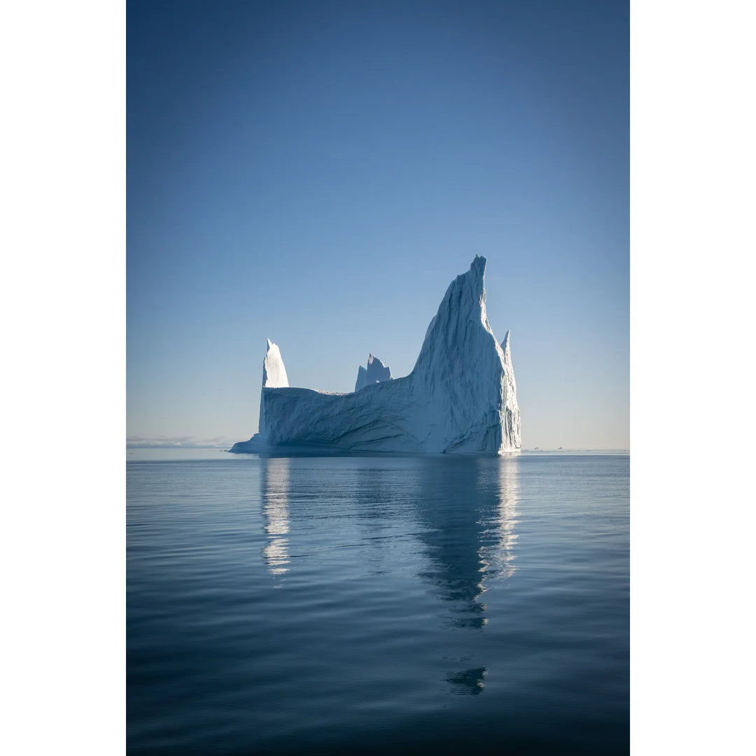 Jagged iceberg with reflection in Scoresby Sound, Greenland, fine art landscape photograph by Peter Cox