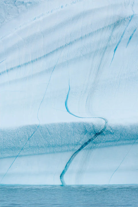 Blue fissures and fracture lines in Greenland iceberg face, Scoresby Sound, fine art landscape photograph by Peter Cox