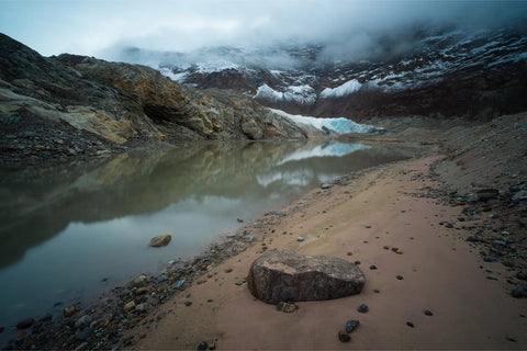 Glacial lake reflecting misty mountains and a turquoise glacier in a remote valley of Scoresby Sund, Greenland, fine art landscape photograph by Peter Cox